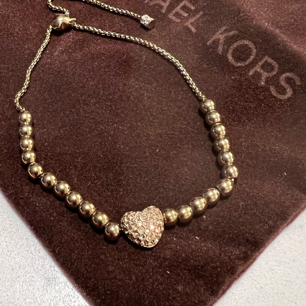Michael Kors bracelet, gold in colour.